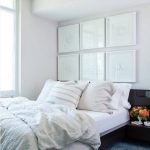 داخل غرفة نوم صغيرة مع صور غير عادية فوق السرير