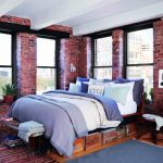 غرفة نوم مع نوافذ كبيرة مع سرير مصنوع يدوياً