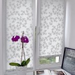 كتاب مفتوح على حافة نافذة من البلاستيك مع الستائر الدوارة